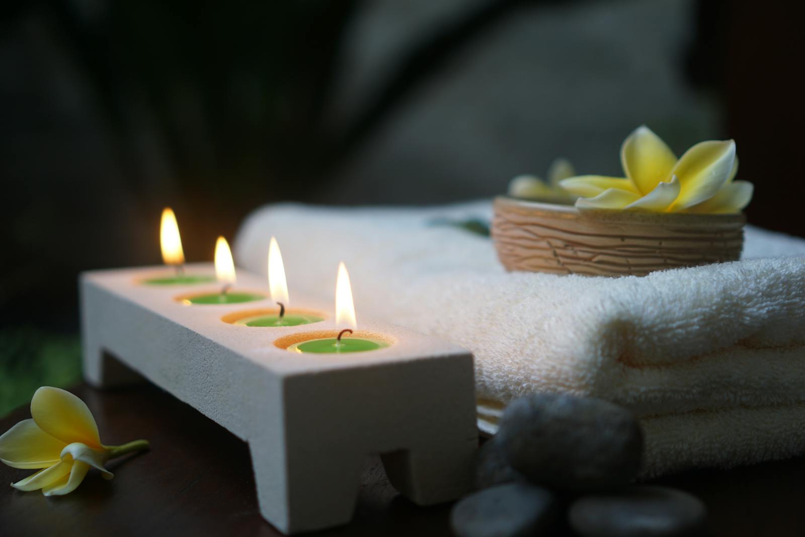 Spa candles with towels and flower setup