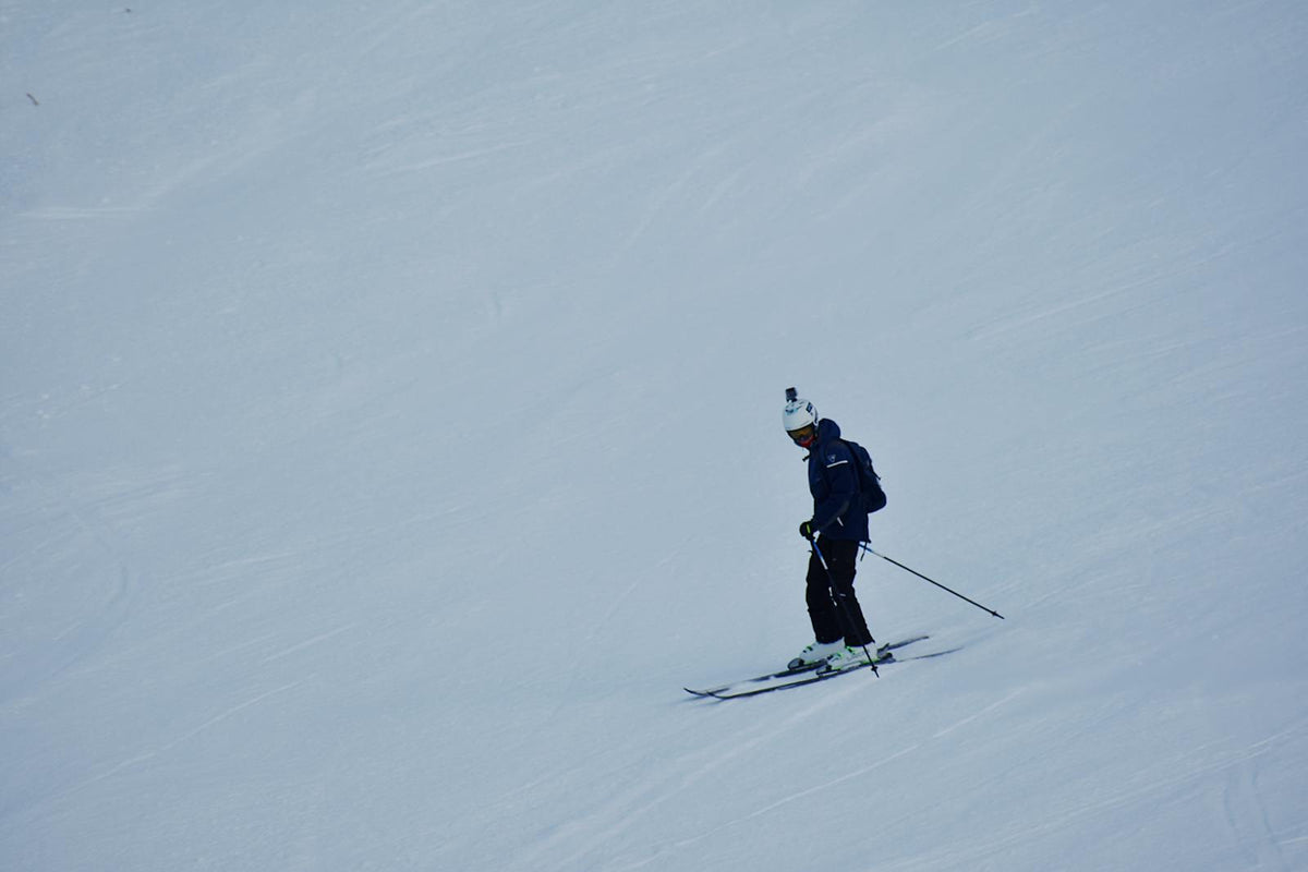 Person skiing on snowy mountain slope