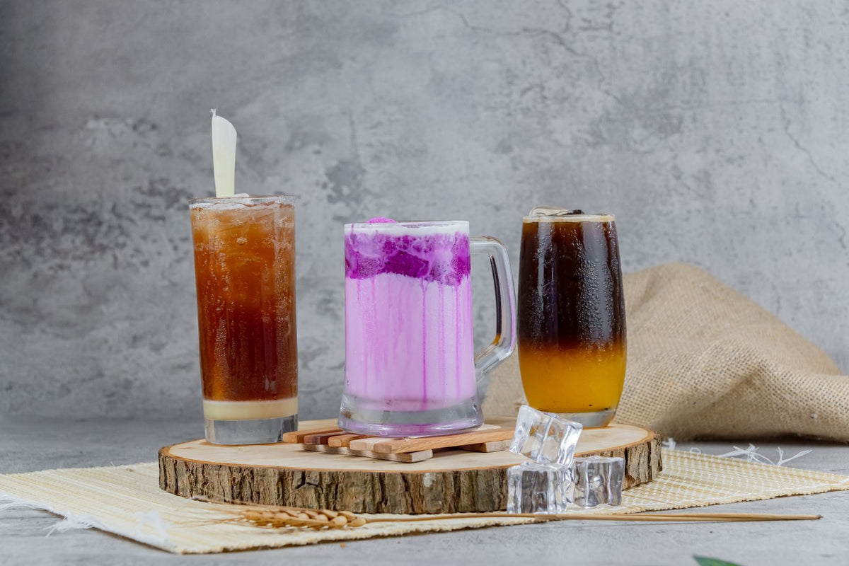 Colorful iced drinks on wooden tray display