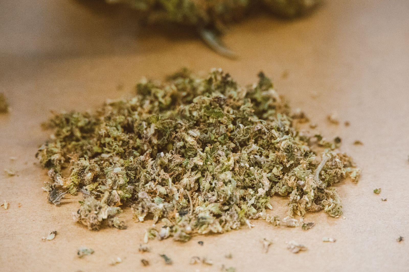 Ground cannabis on brown paper surface
