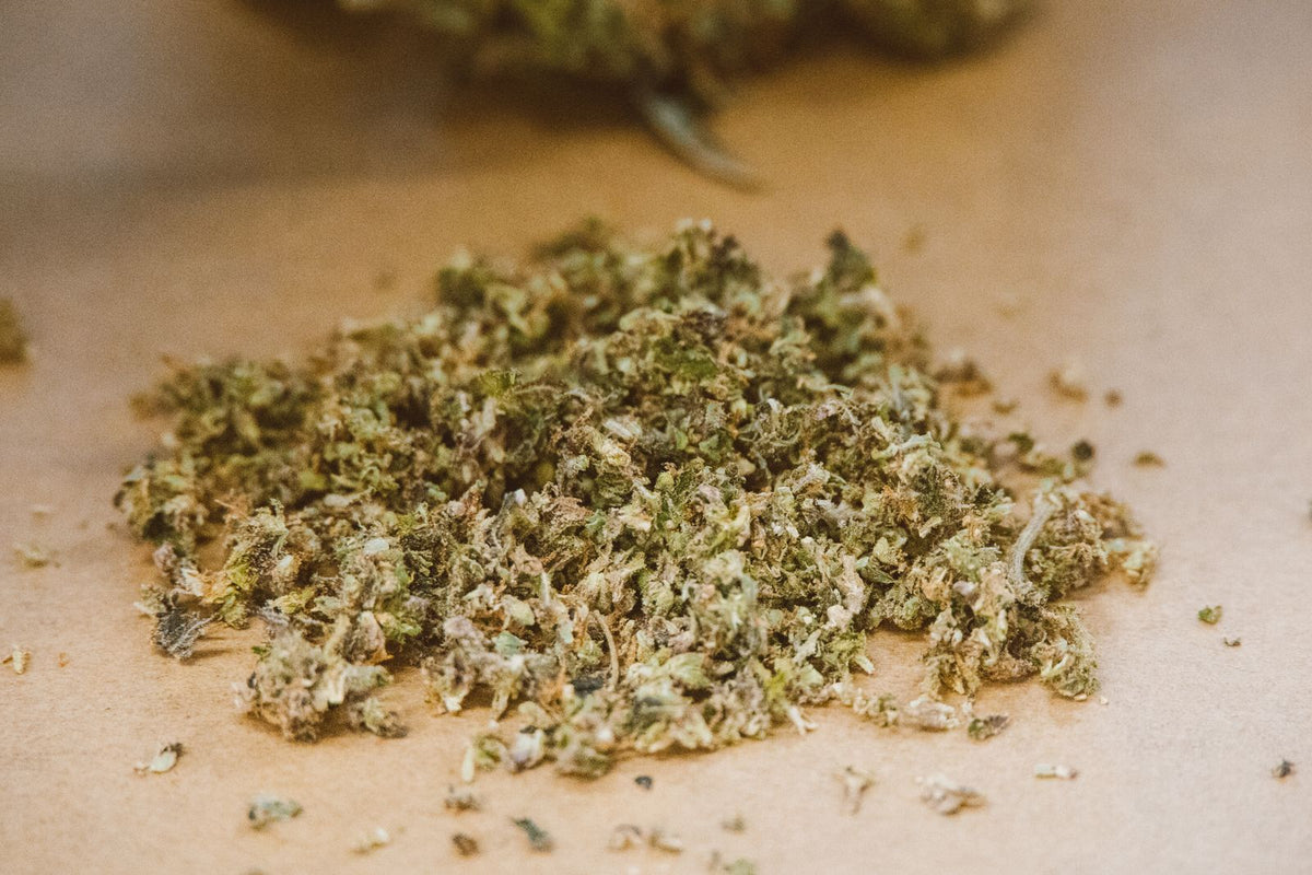 Ground cannabis on brown paper surface