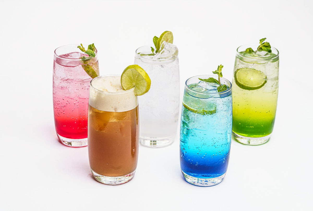 Colorful refreshing summer cocktails with lime garnish