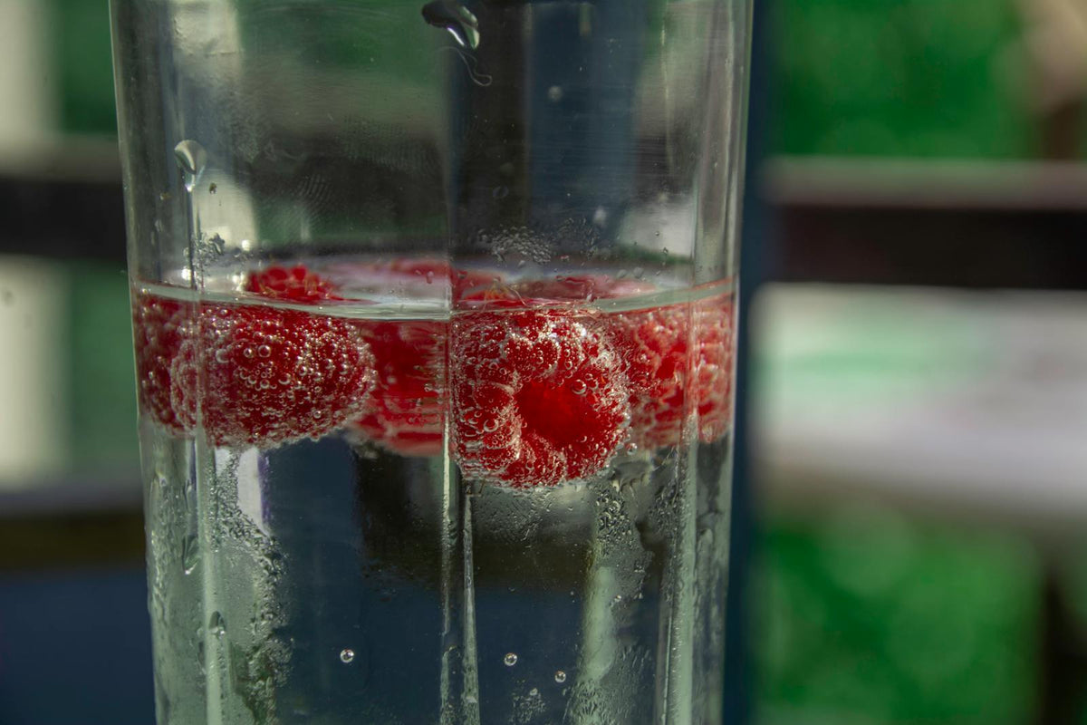 Raspberries in sparkling water glass