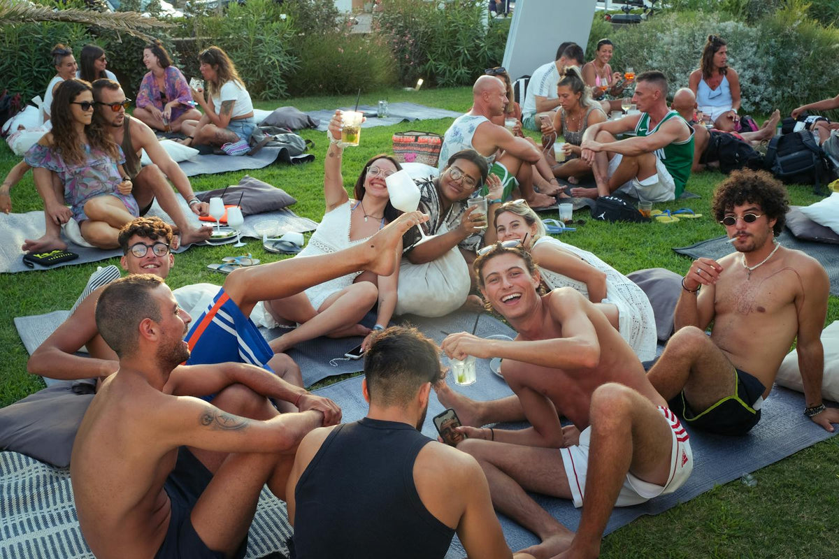 Outdoor gathering with friends on grass mats