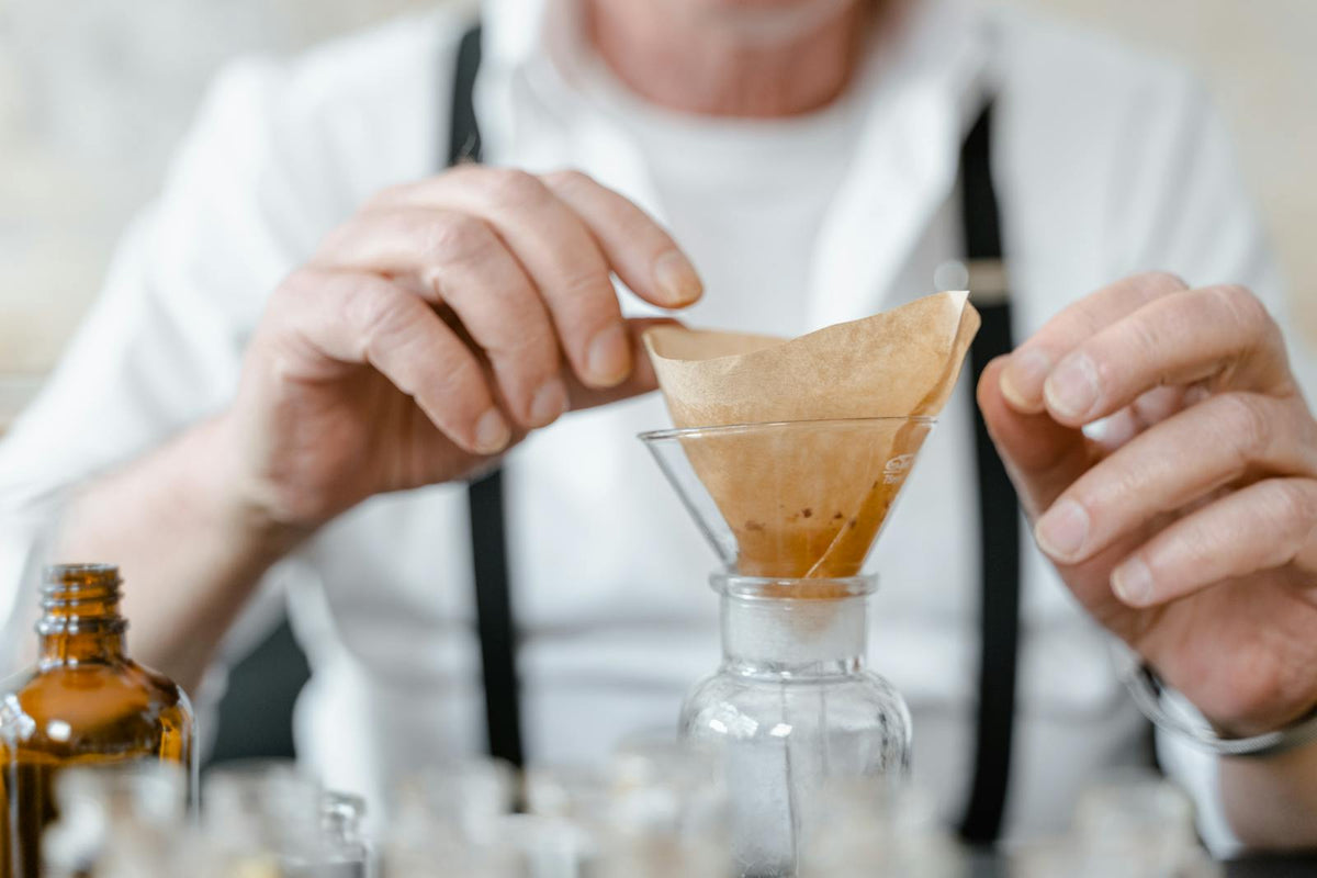 Person using filter paper in laboratory setting