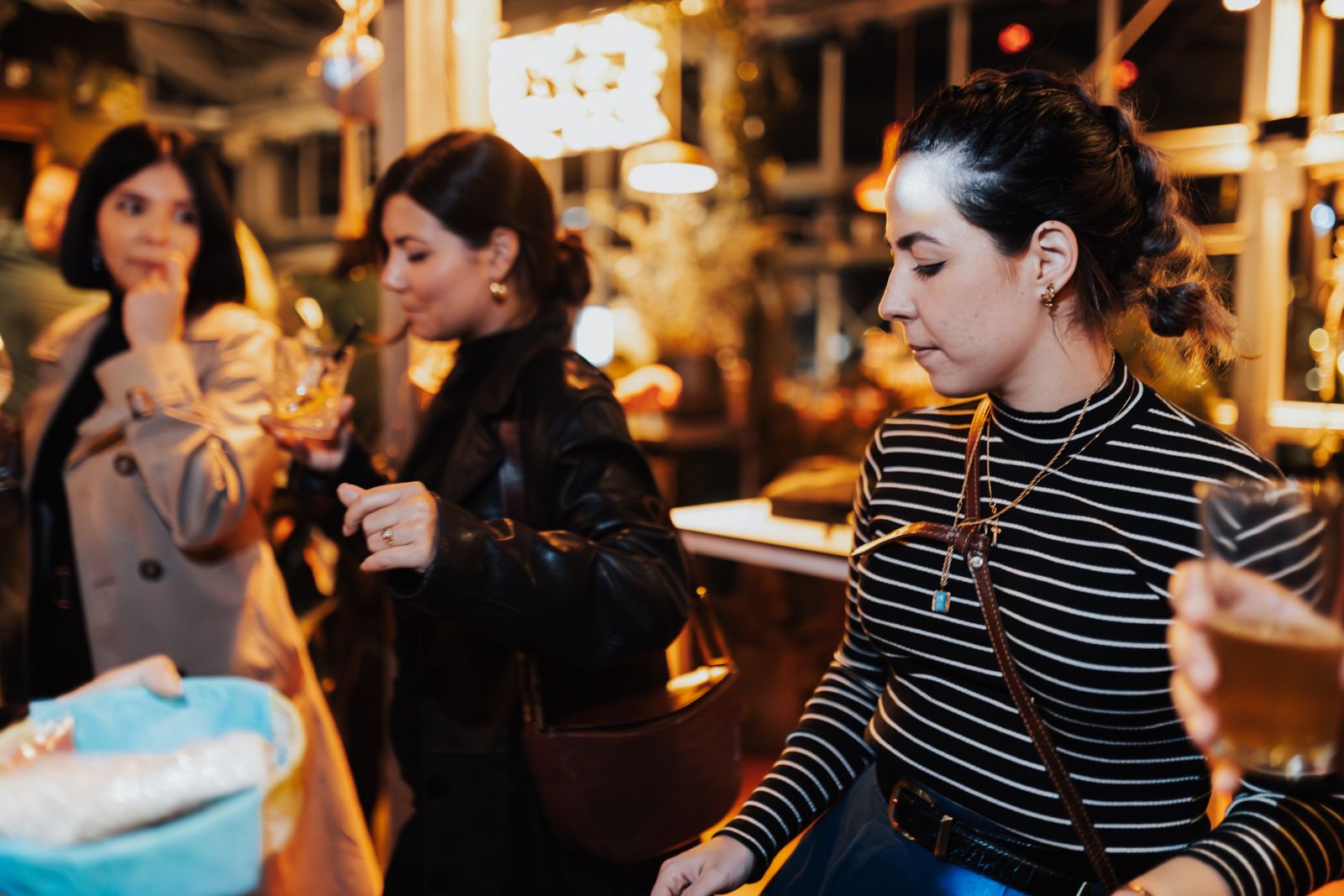 Women enjoying drinks at a lively party