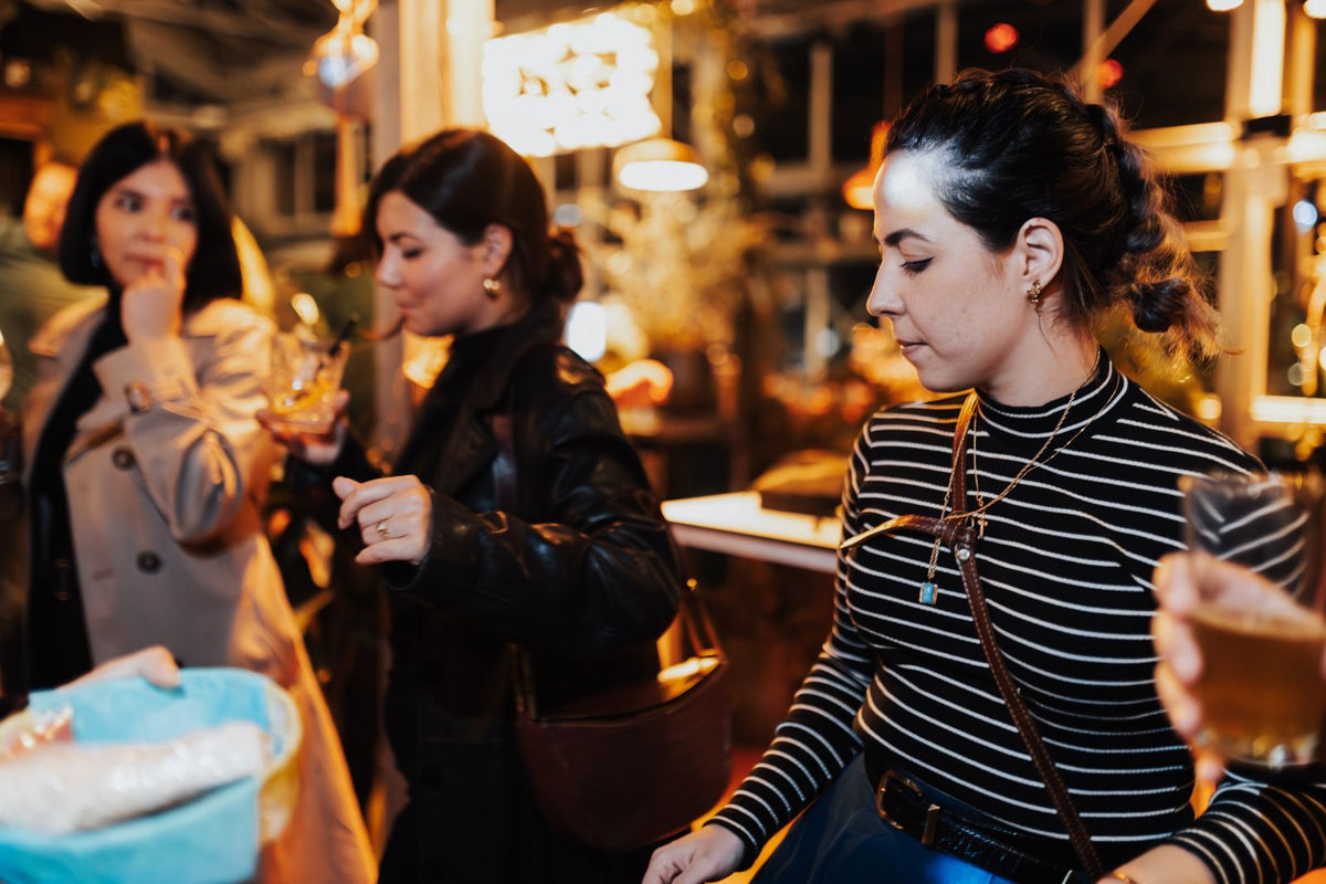 Women enjoying drinks at a lively party