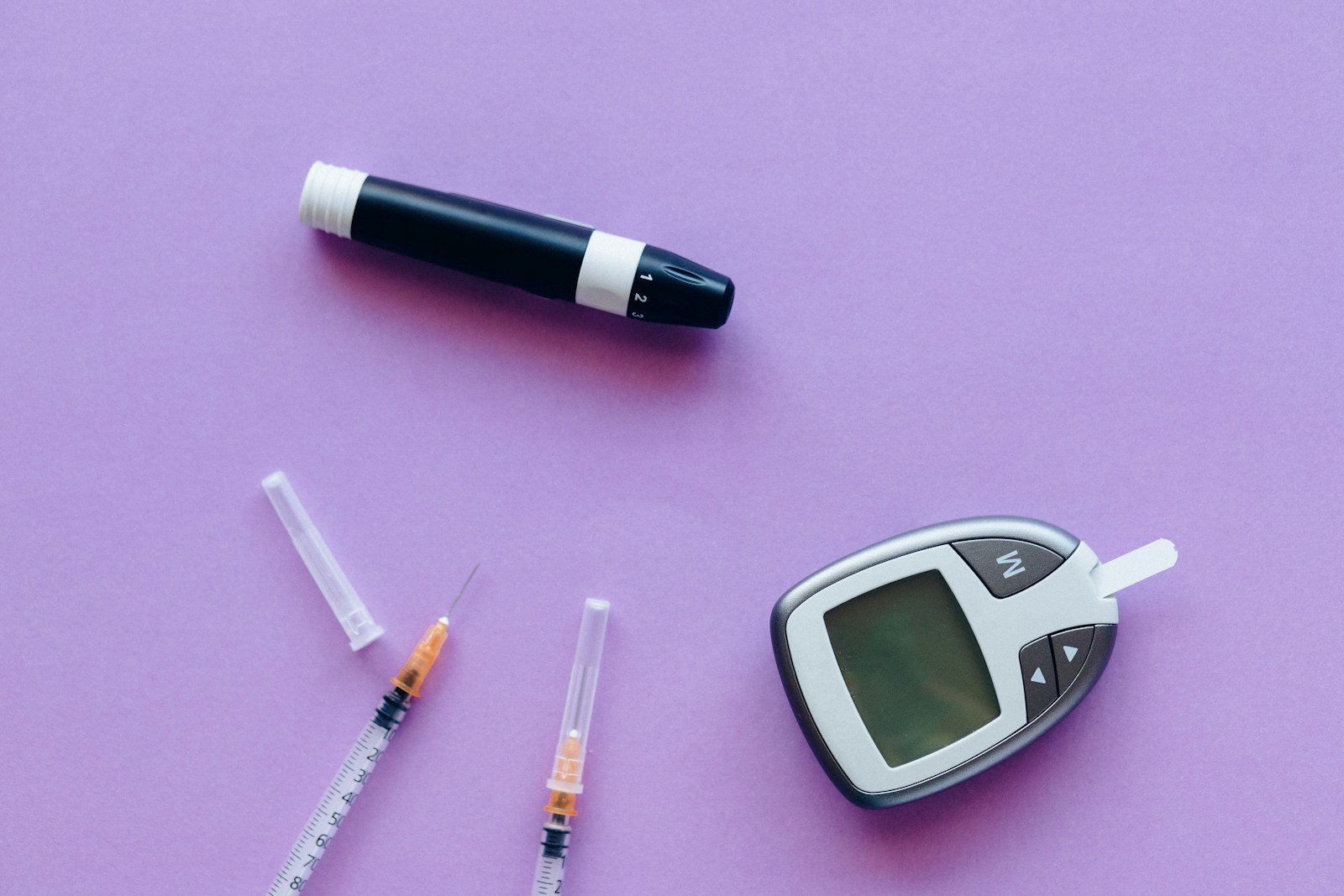 Diabetes supplies on purple background