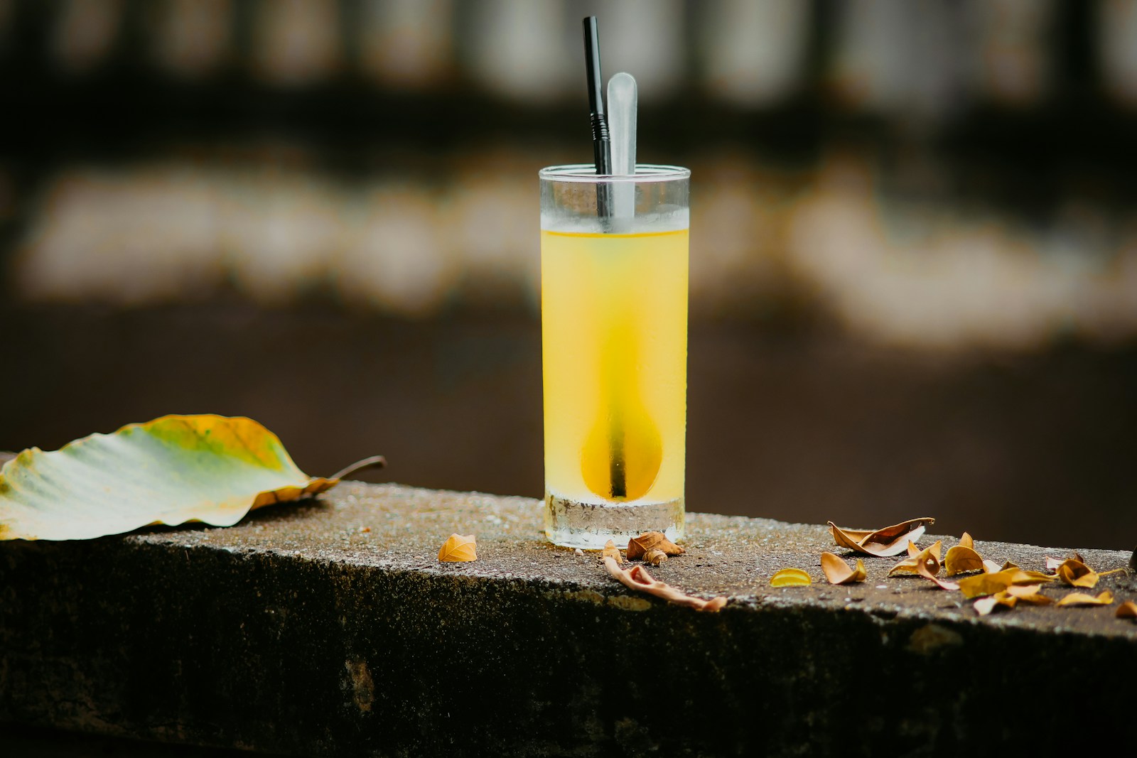 Refreshing yellow drink with fall leaves