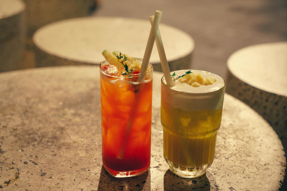 Colorful cocktails with straws on table