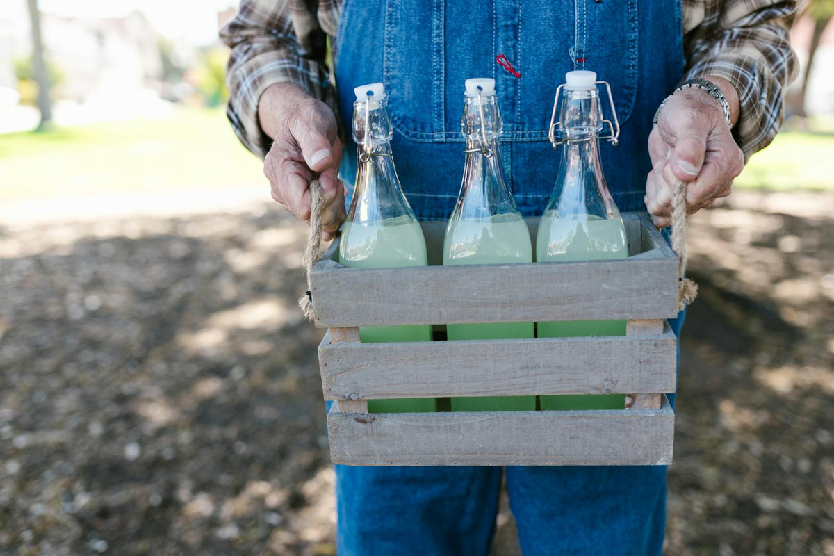 Farmer holding crate of lemonade bottles