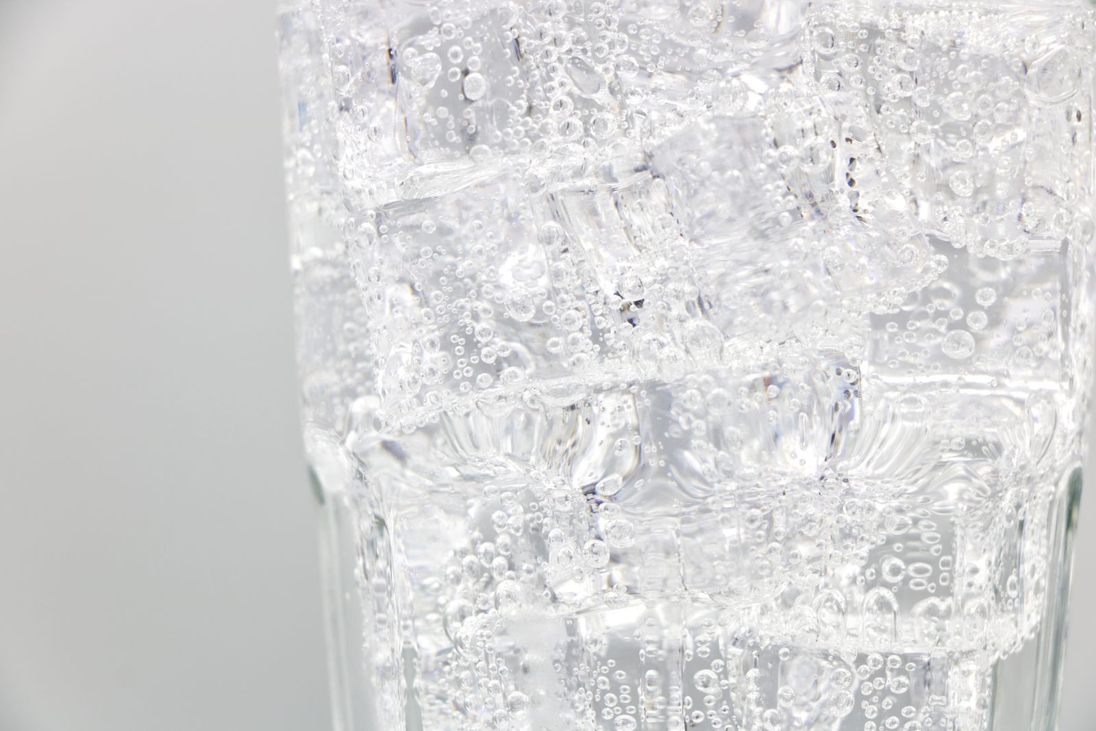 Sparkling water with ice cubes closeup