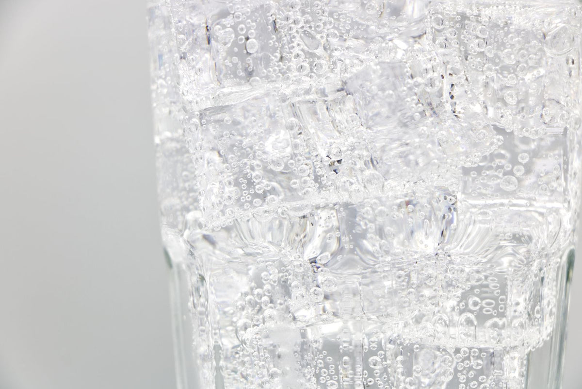 Sparkling water with ice cubes closeup