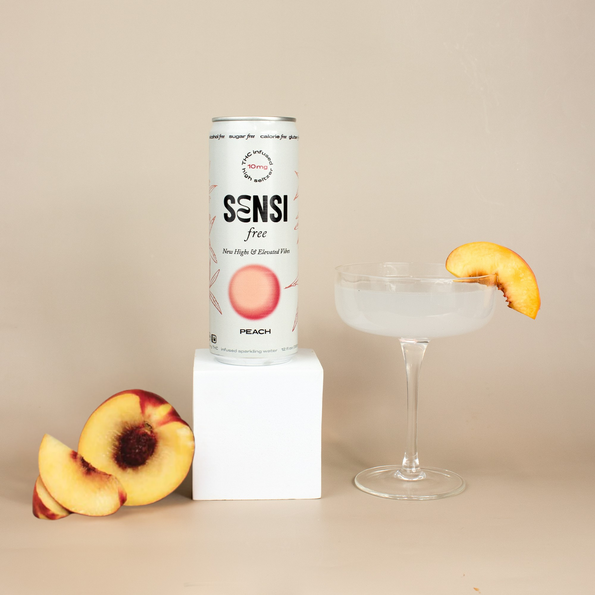 Sensi free peach can with glass next to it