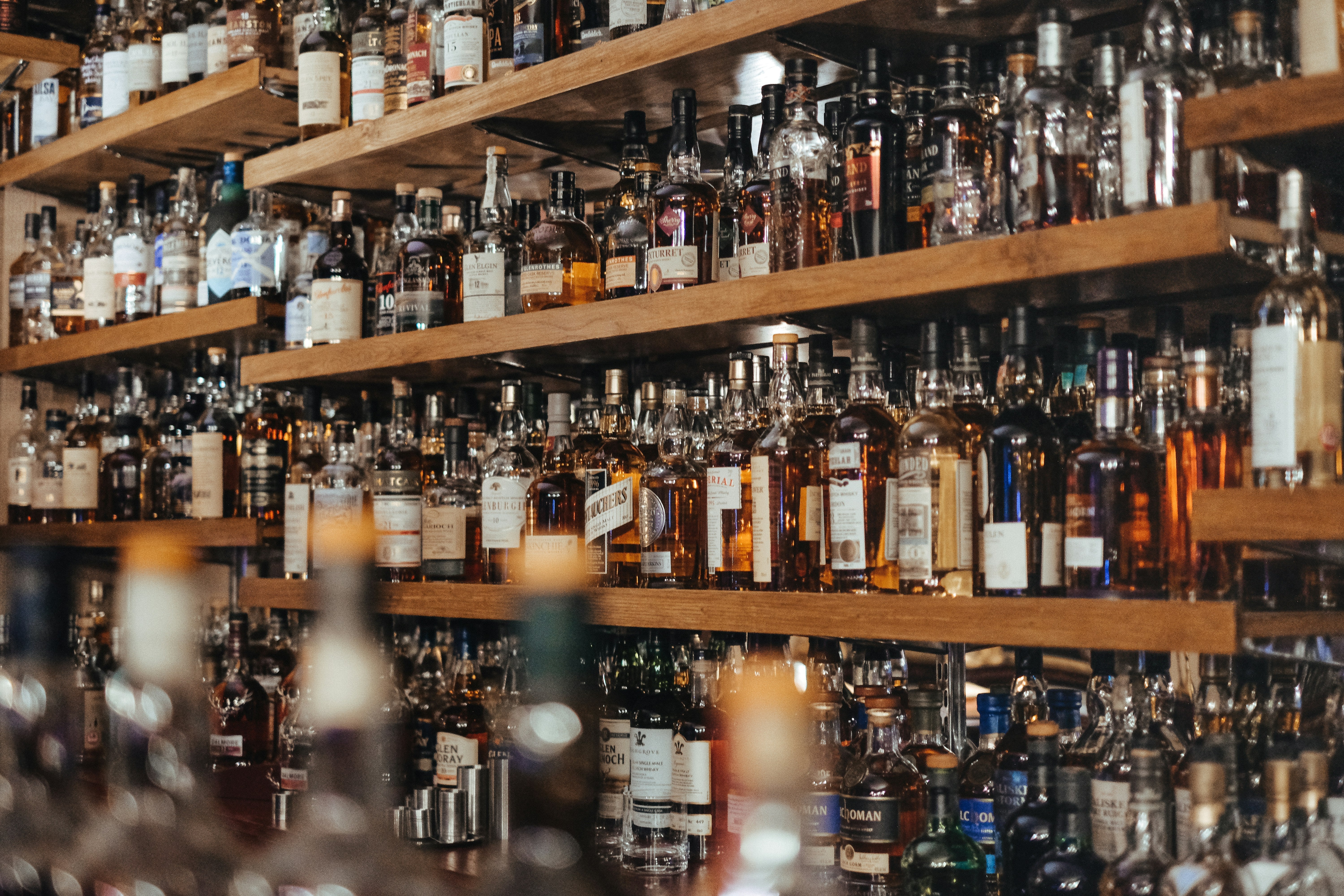 Bar shelves with various liquor bottles