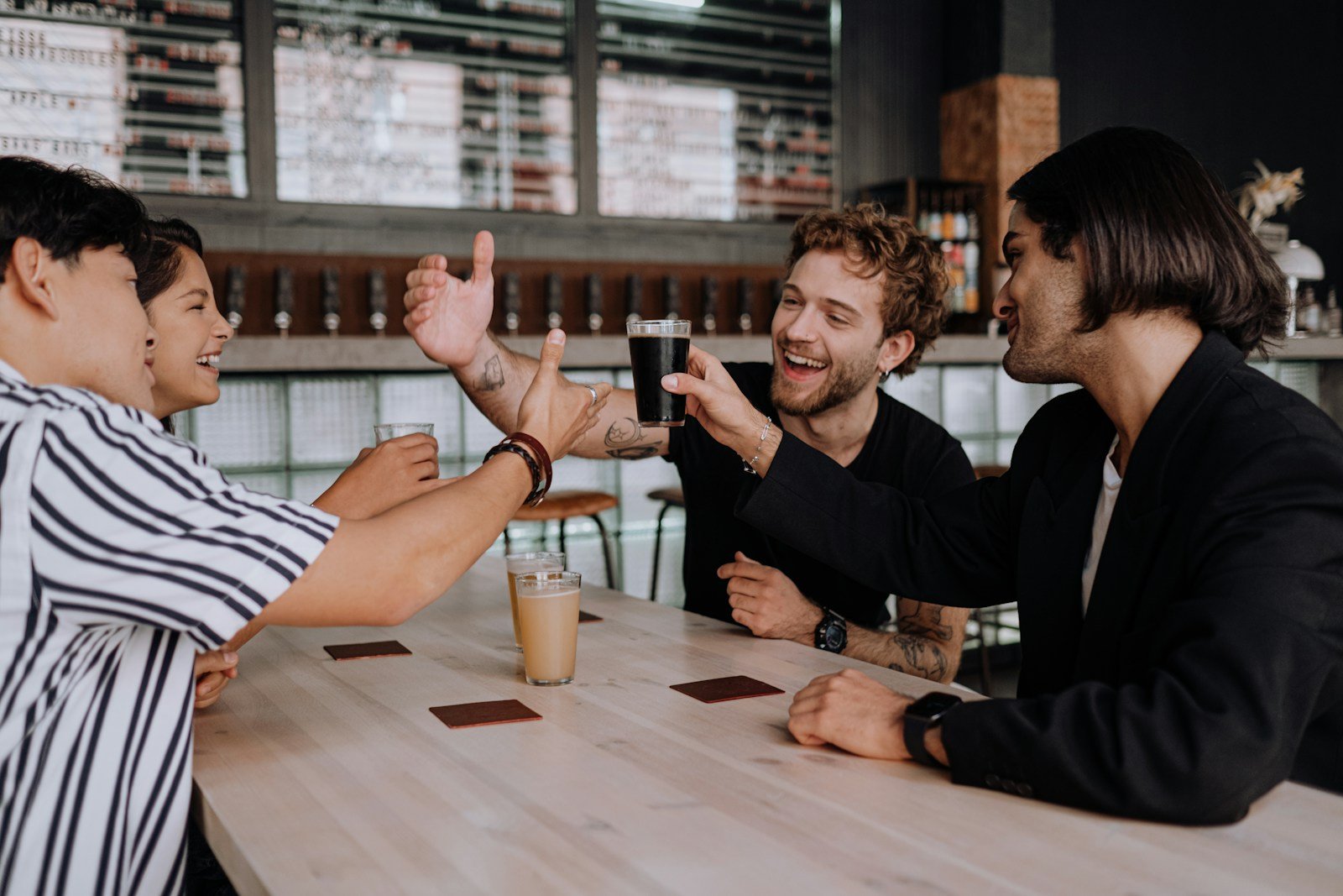 Friends toasting drinks at a bar