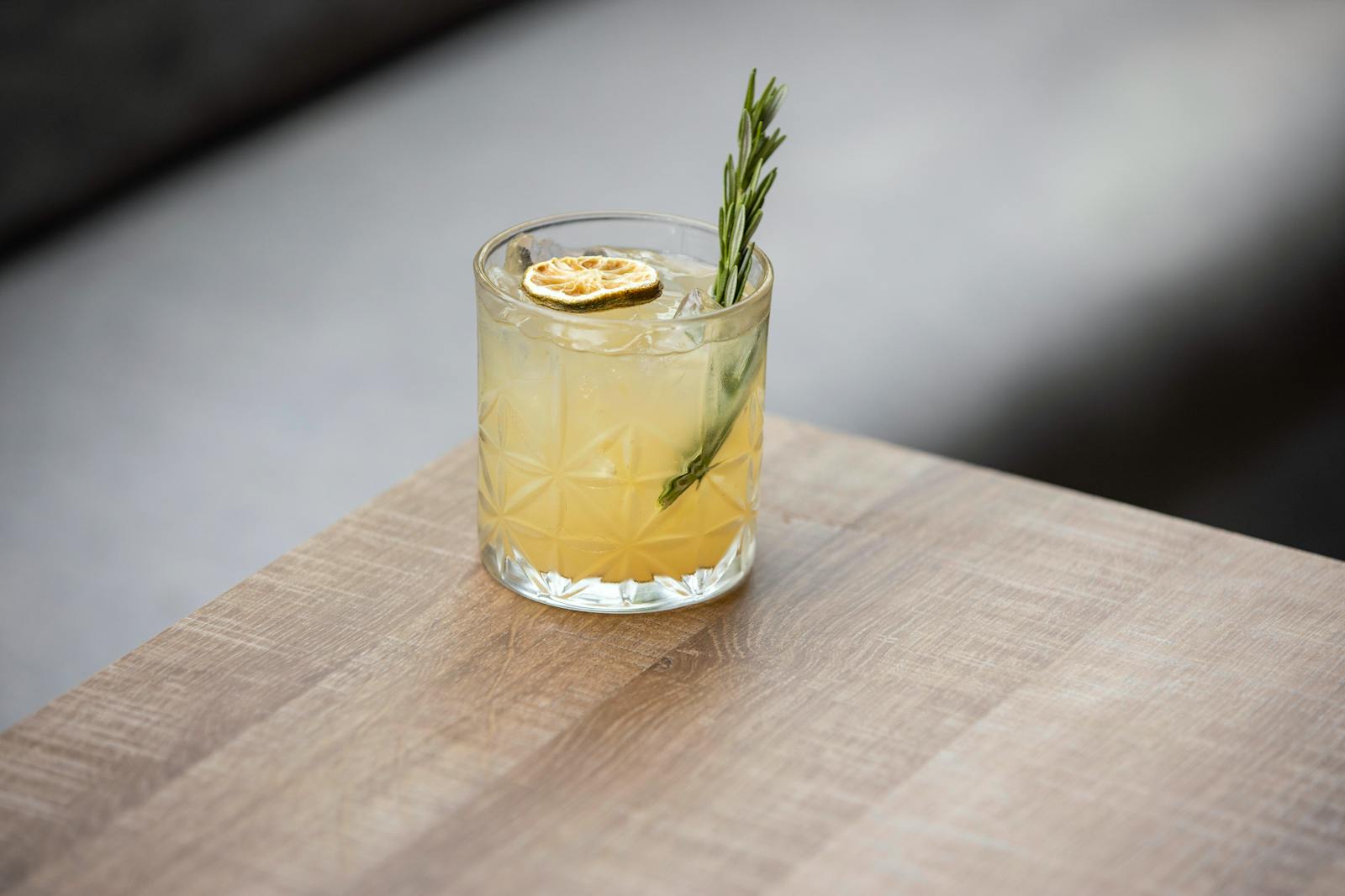 Refreshing cocktail with rosemary and citrus garnish