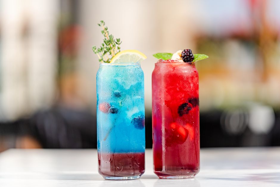 Blue and red berry drinks in tall glasses