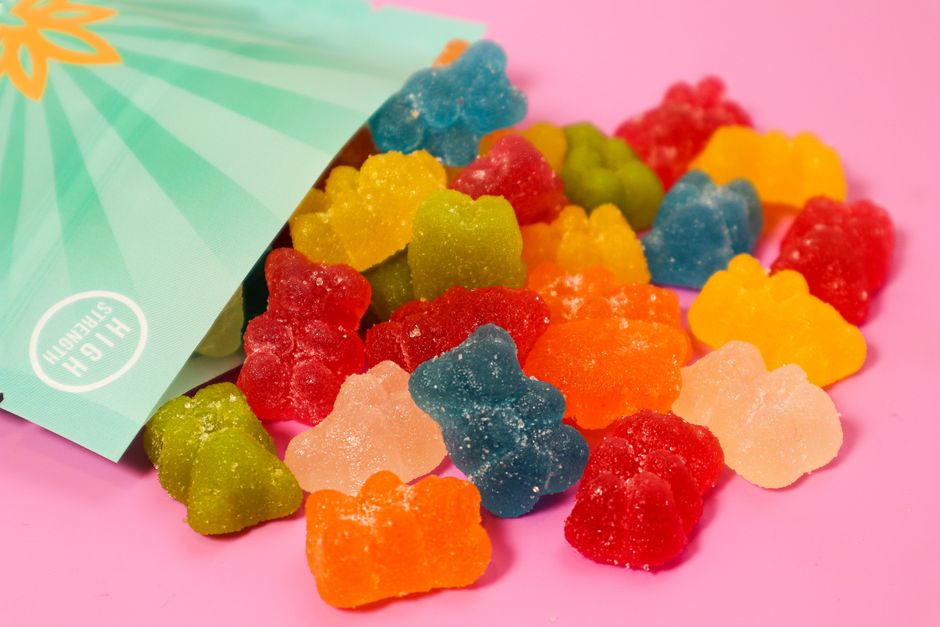 Assorted gummy bears spilling from a bag