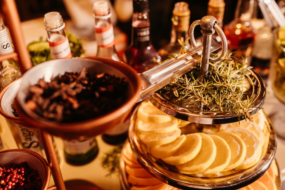 Lemon slices, herbs, bottles, and spices arranged