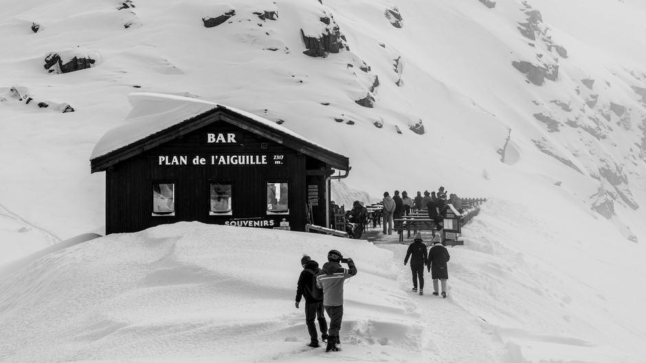 People near a bar on a snowy mountain
