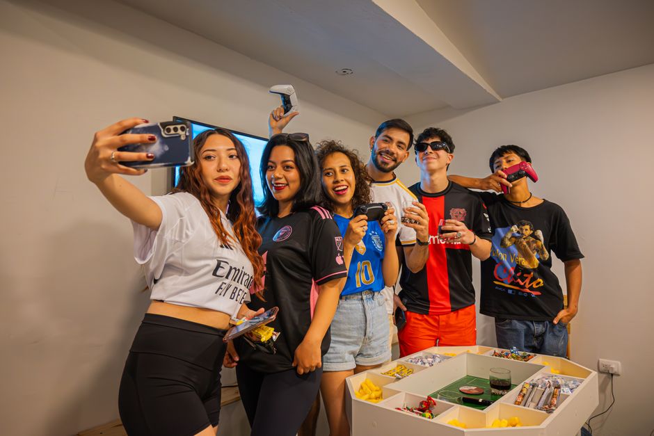 Six friends posing with controllers and snacks