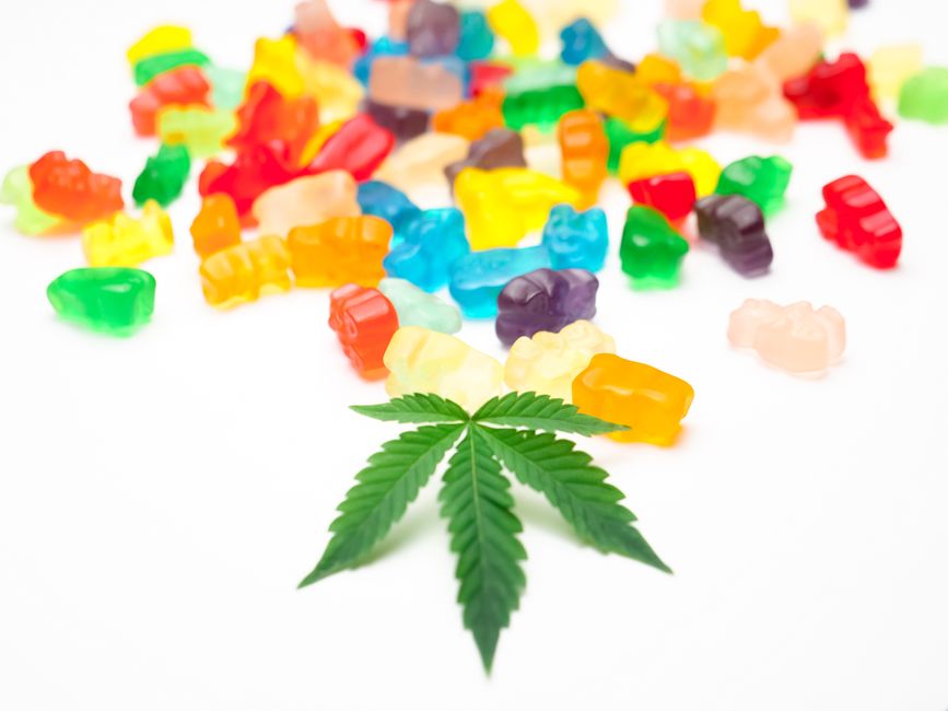 Colorful gummy bears with a cannabis leaf
