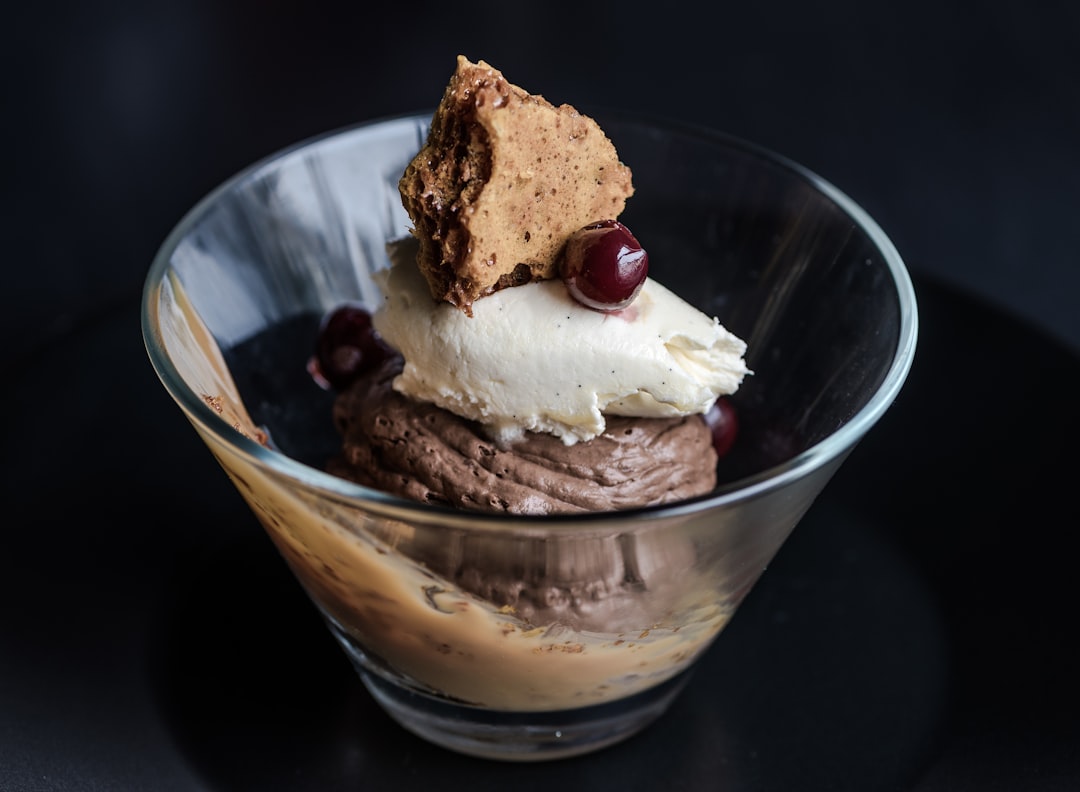 Glass with chocolate mousse, cream, cherries, honeycomb