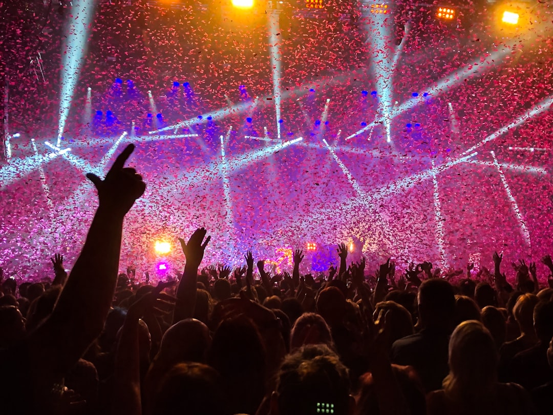 Audience at concert under confetti and lights
