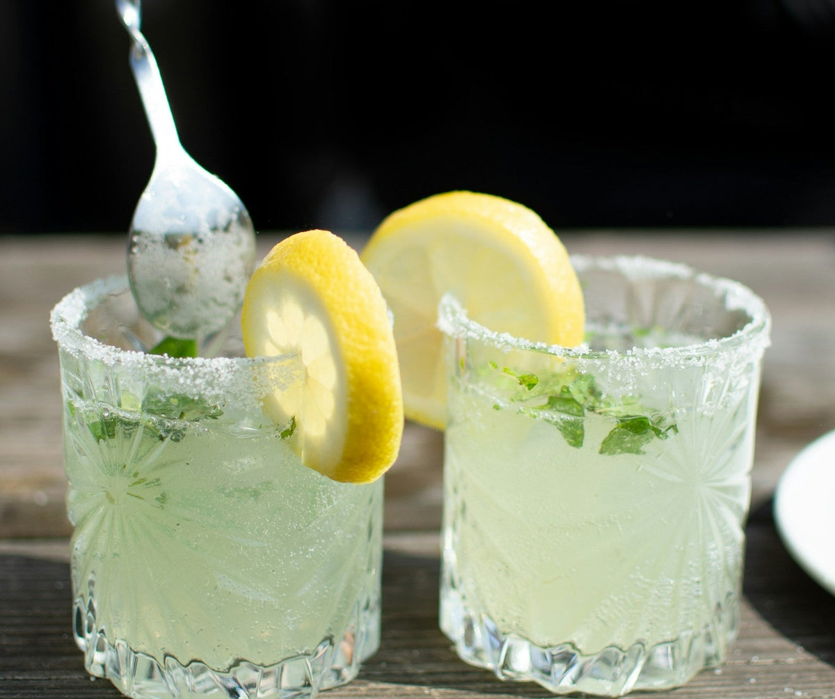 Refreshing lemon mint cocktail in crystal glasses