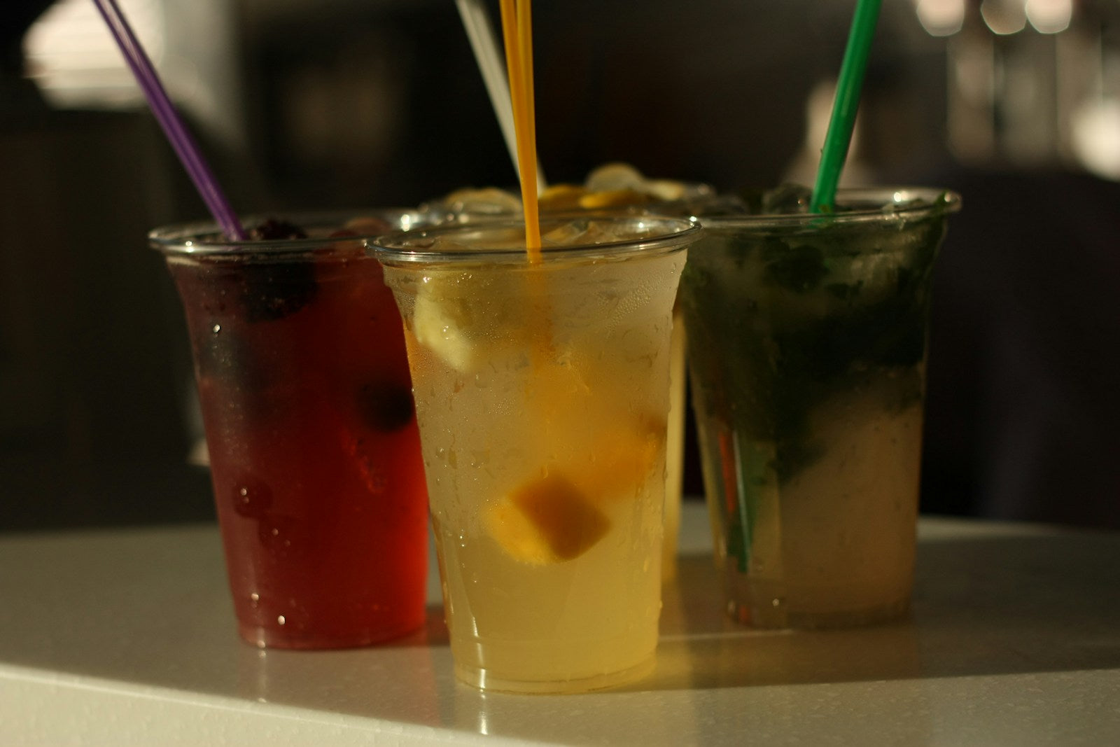 Colorful refreshing summer drinks with straws