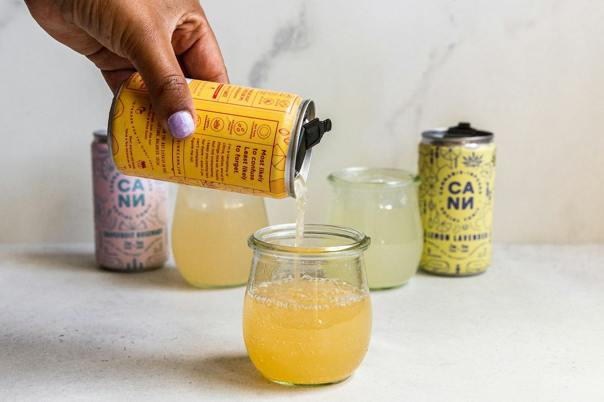 Pouring sparkling drink into glass jar