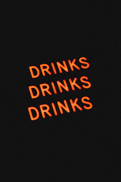 Neon drinks sign on black background