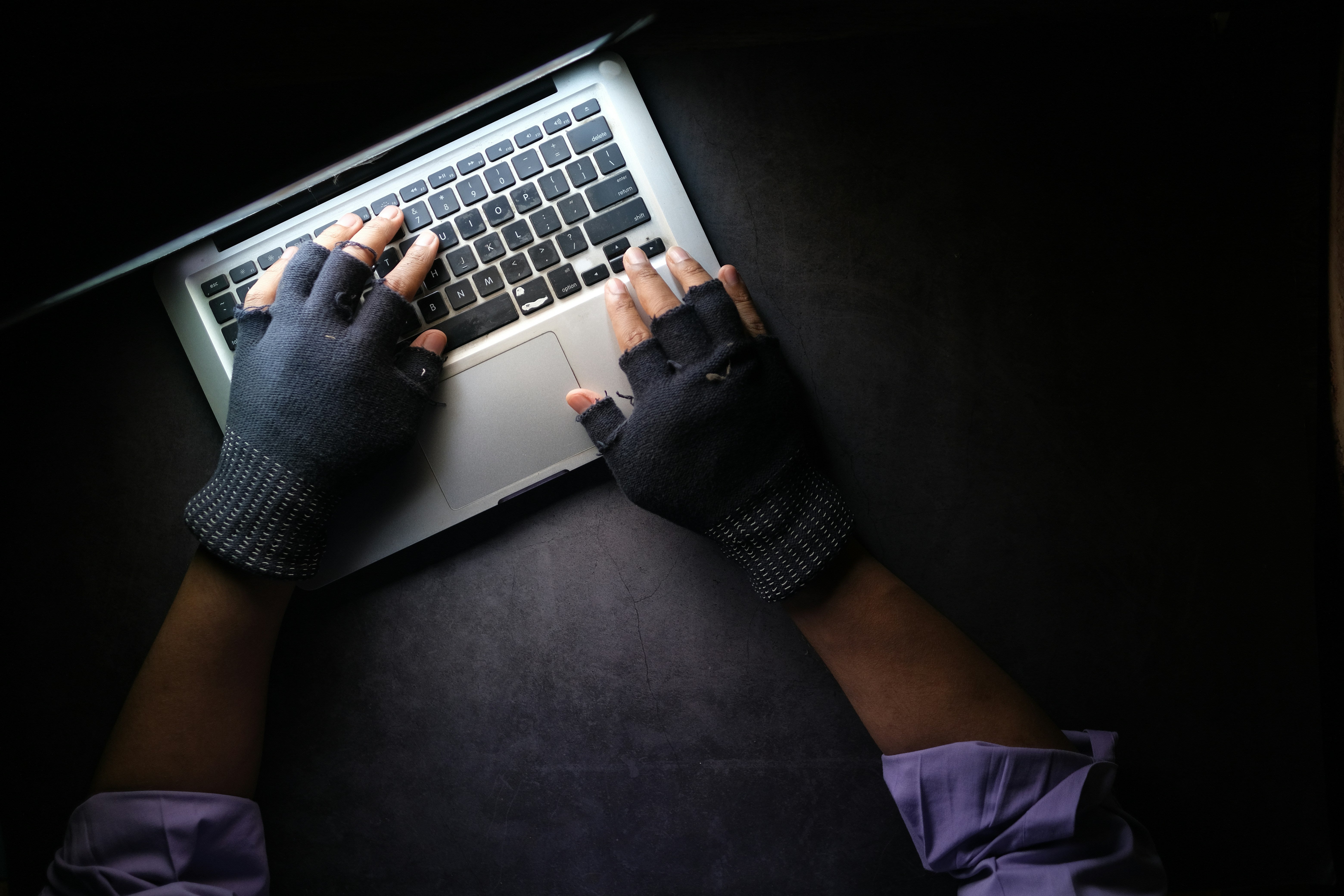 fingerless cloves on keyboard in the dark
